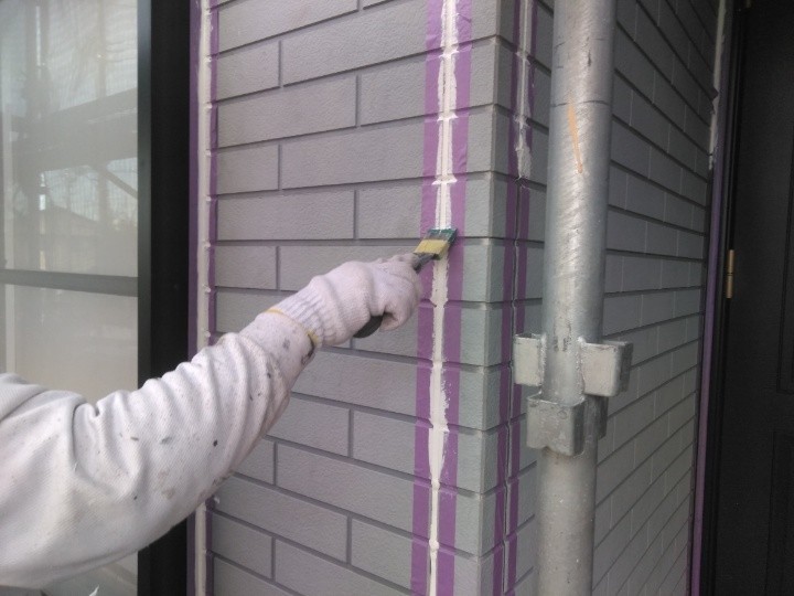 コーキングをヘラで整える作業